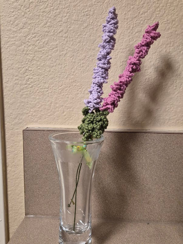 Two-stem lavender and pink cotton yarn arrangement shown in a clear vase, vase not included