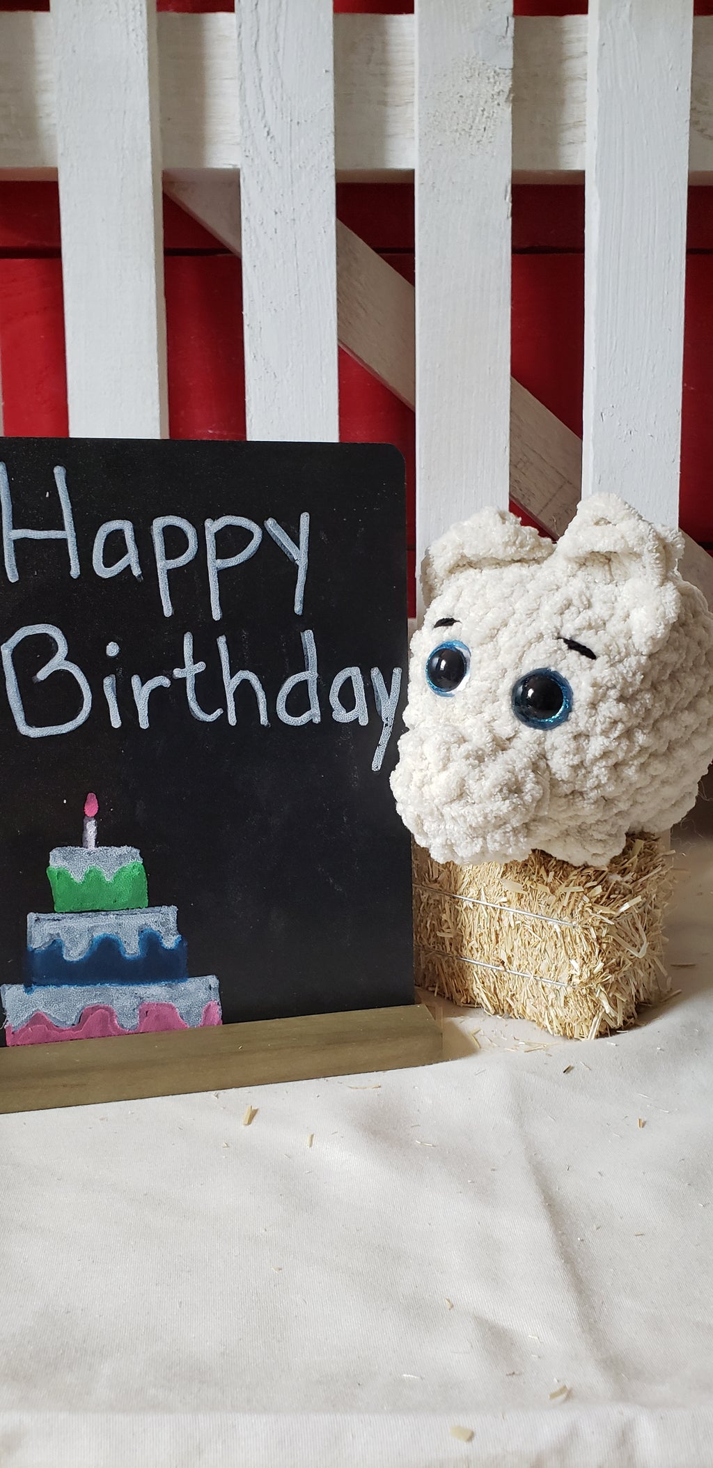 Almond crocheted mini pig plushie close-up face with Happy Birthday sign