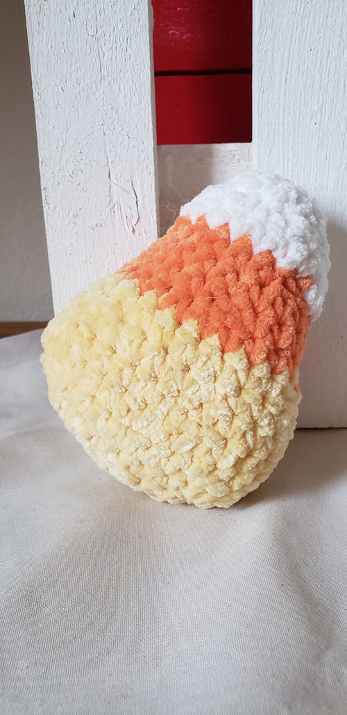 Crochet candy corn plushie side profile showing white, orange and yellow color bands