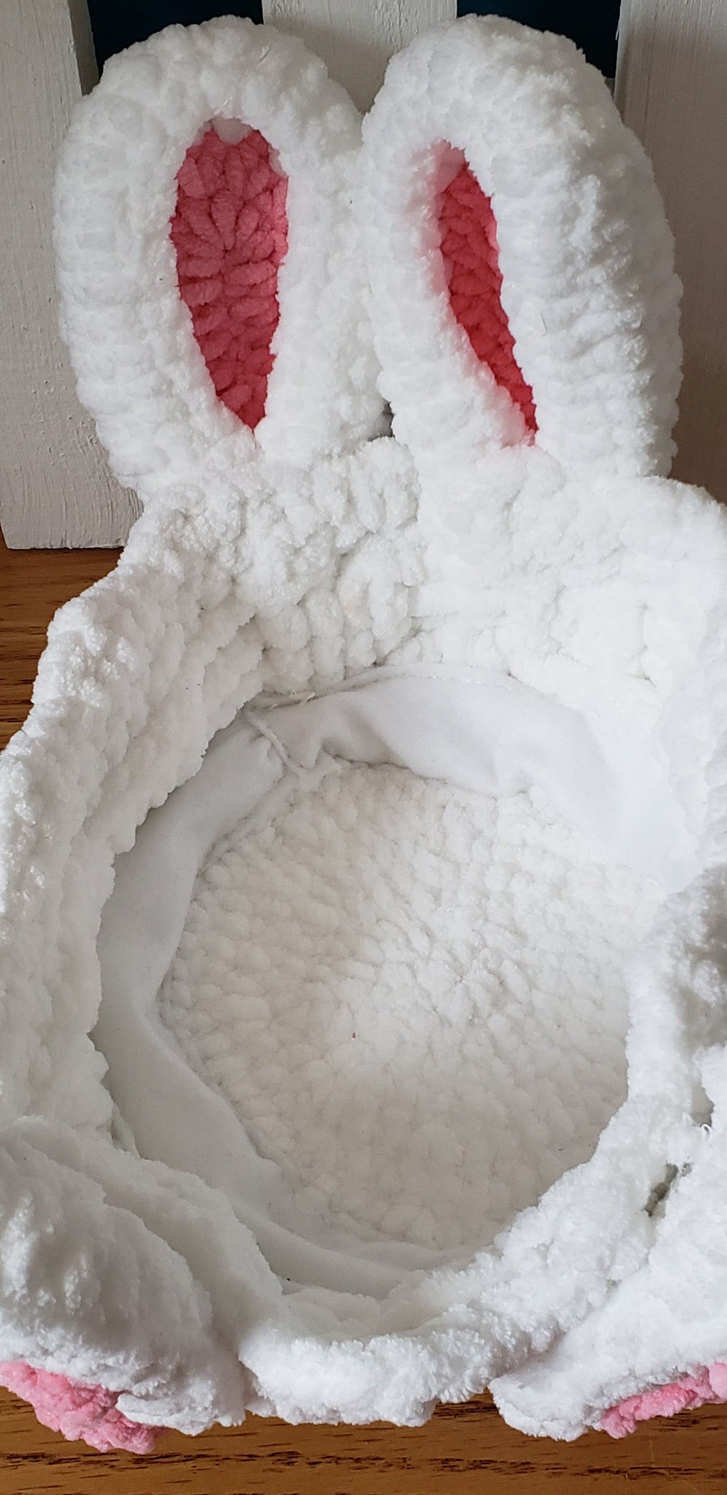 Inside of crochet Easter bunny basket showing felt lining and 5 colorful crochet eggs