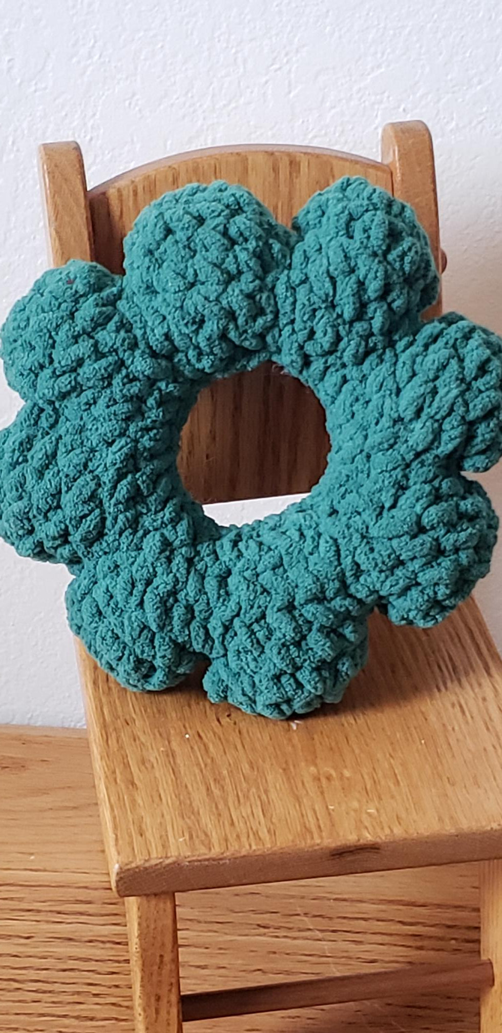 Crochet plush mini Christmas wreath back view showing teal green plush texture and round shape