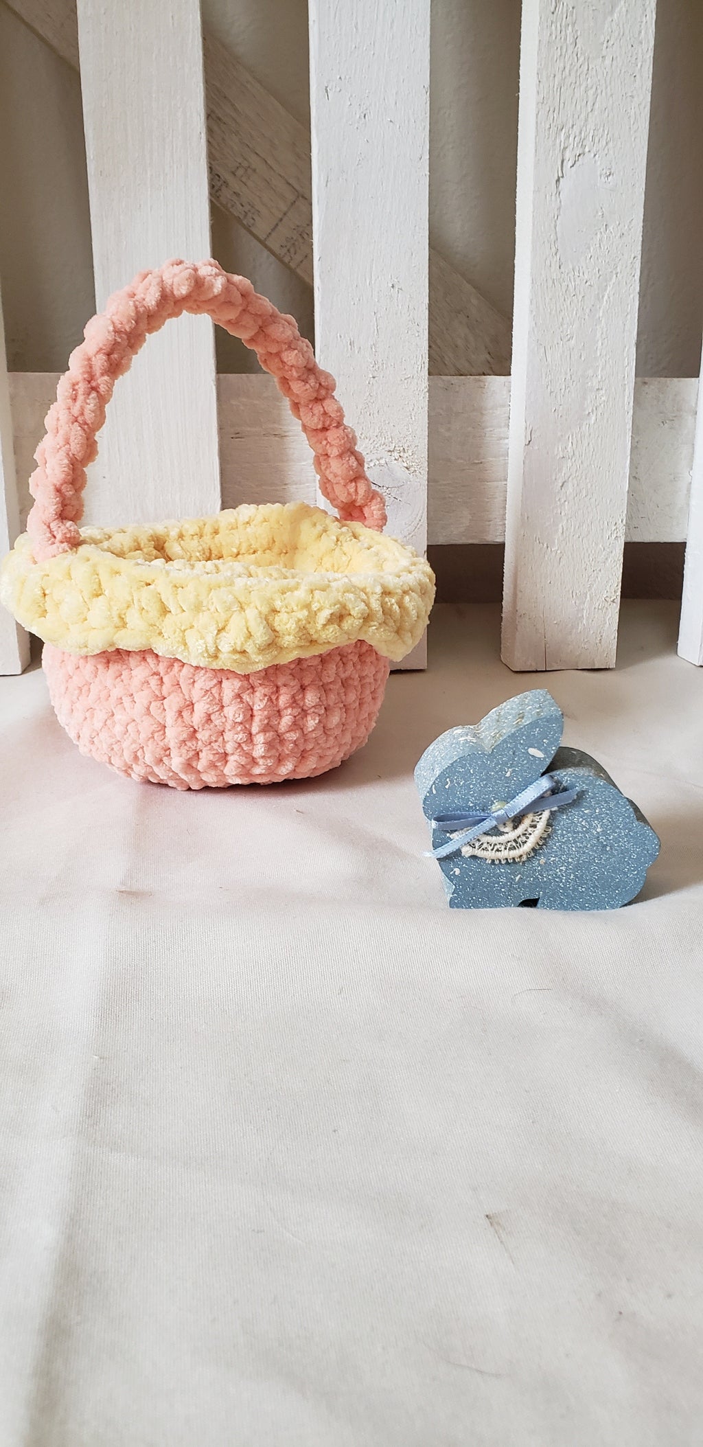 Small peach crochet Easter basket with yellow lining and braided handle - main view with Easter bunny