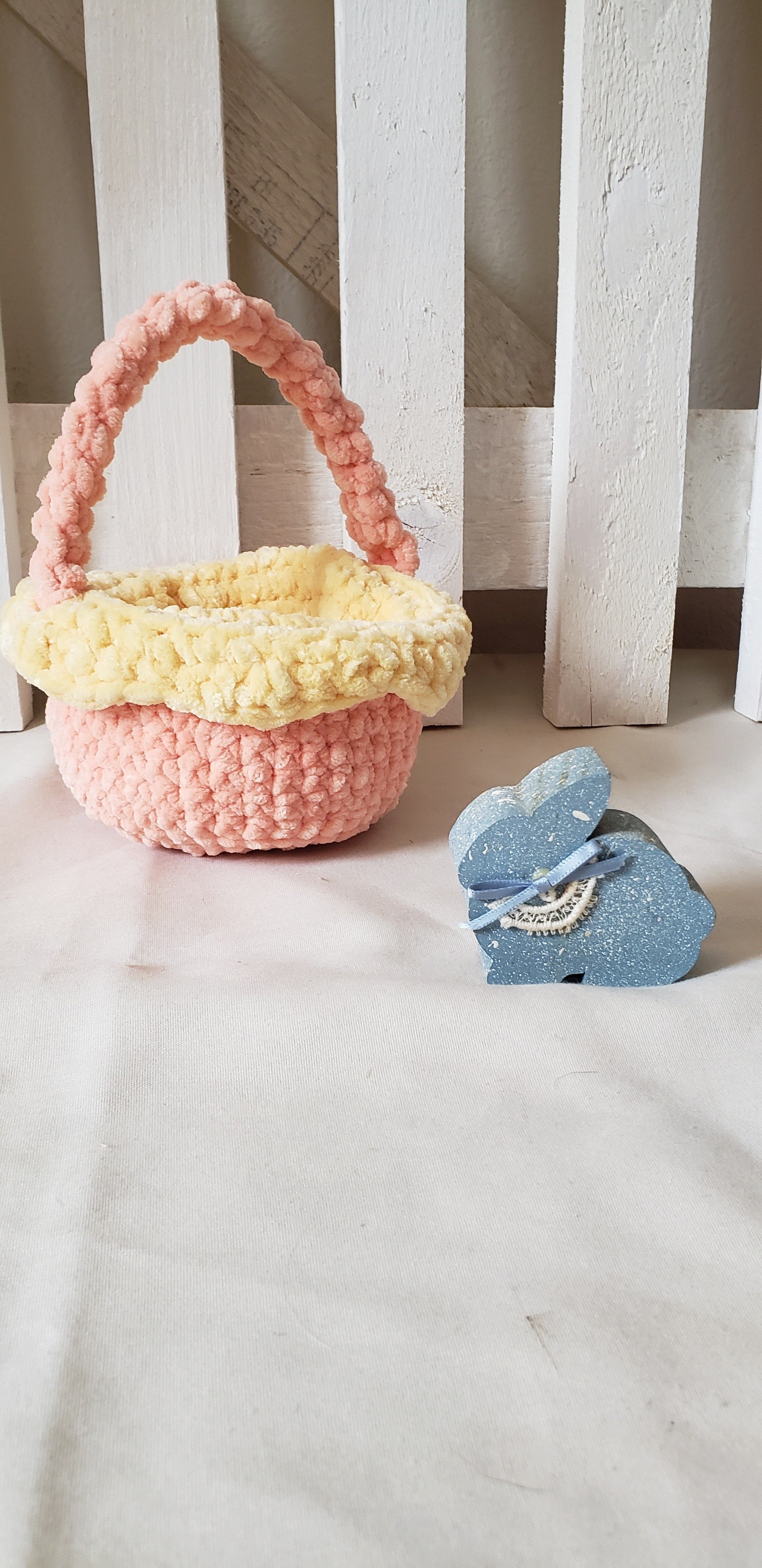 Small peach crochet Easter basket with yellow lining and braided handle - main view with Easter bunny