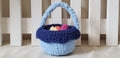 Two-tone blue crochet Easter basket with light blue and navy lining, eggs inside - front view