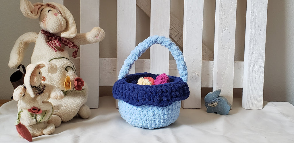 Two-tone blue crochet Easter basket glamour shot with Easter bunny figurines
