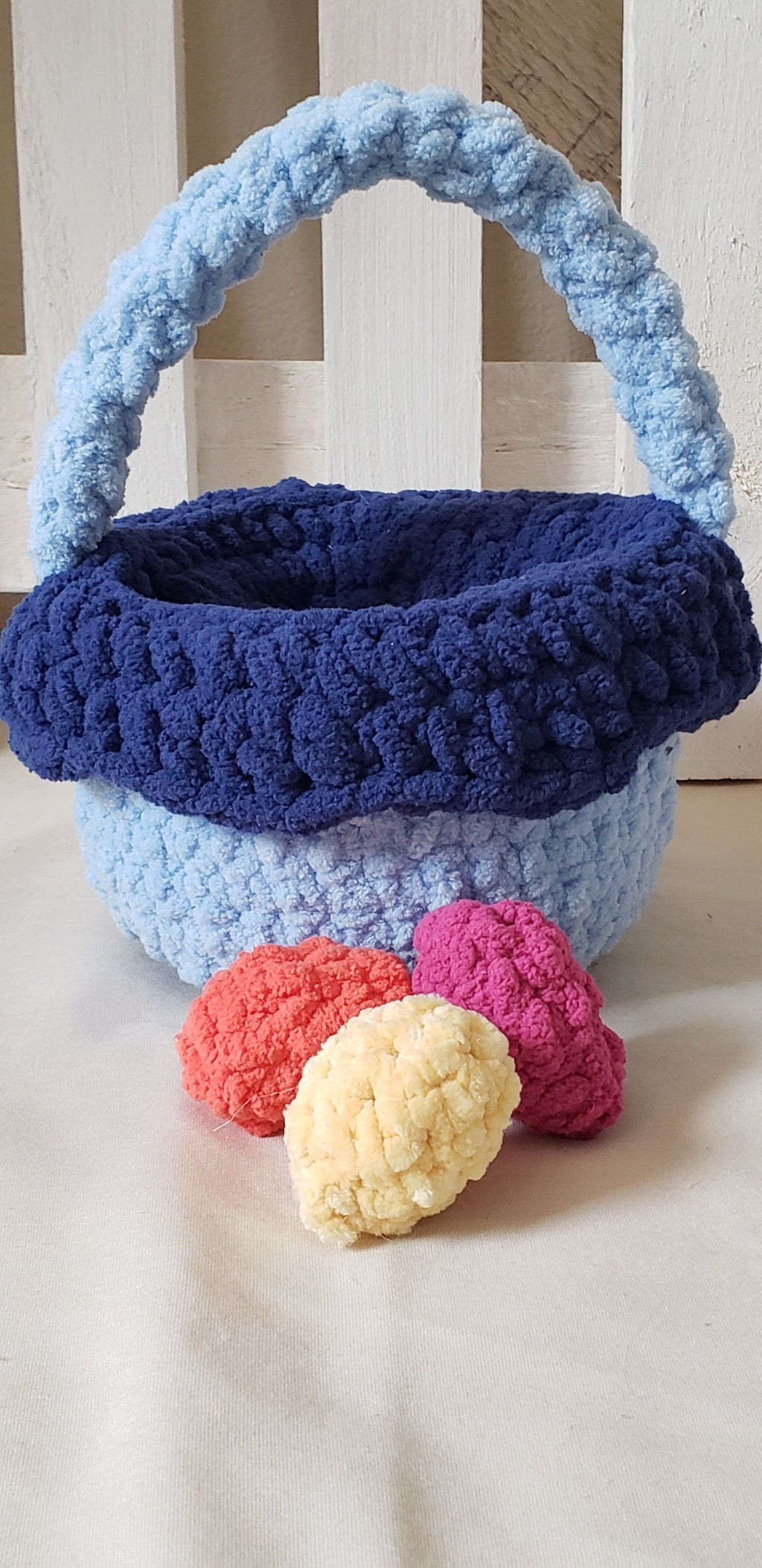 Two-tone blue crochet Easter basket main view showing light blue body and navy lining