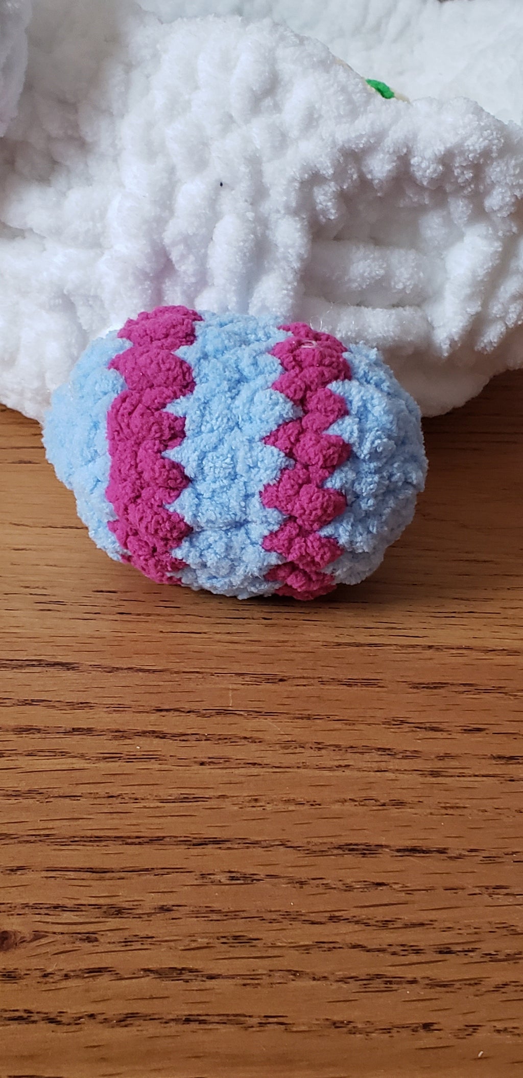 Light blue and fuchsia zigzag patterned crochet Easter egg close-up