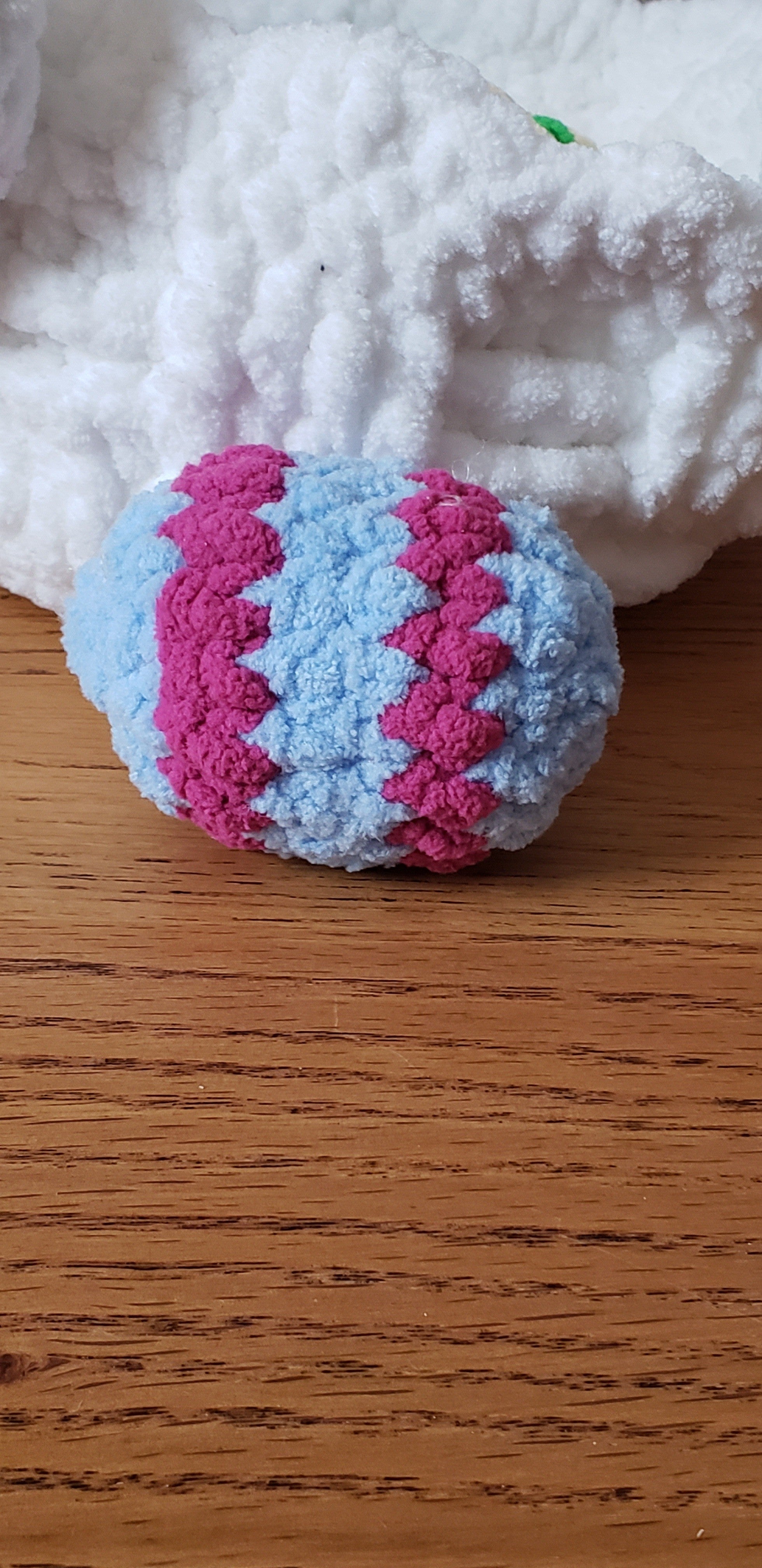 Light blue and fuchsia zigzag patterned crochet Easter egg close-up