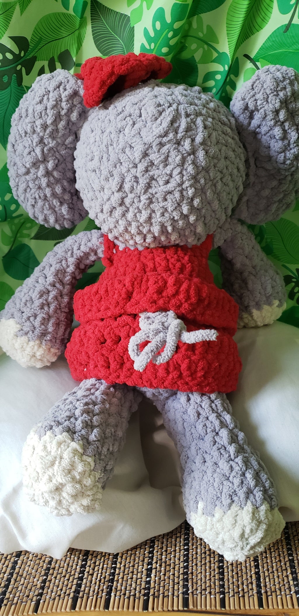 Crocheted elephant plushie back view showing red dress detail