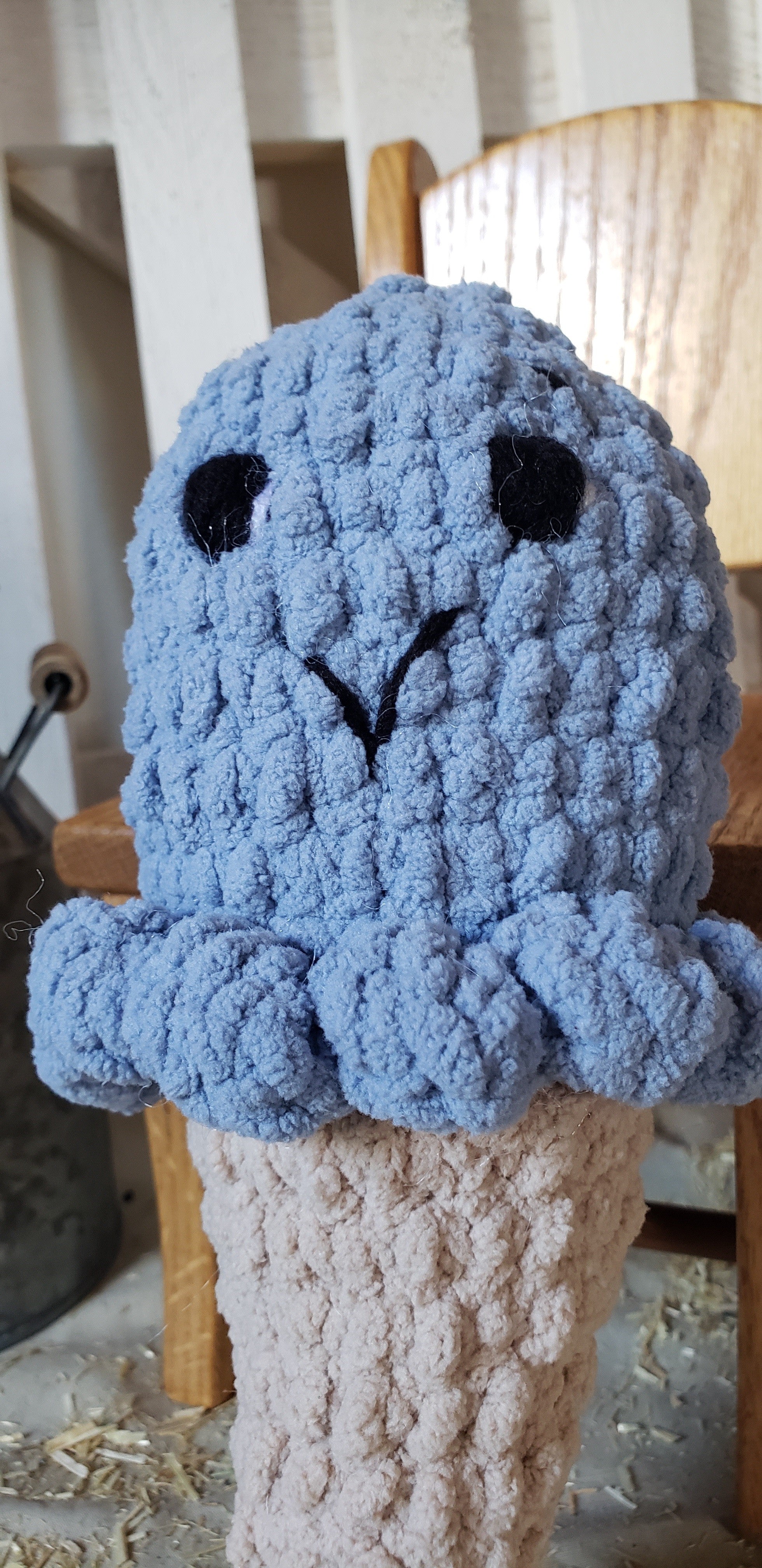 Close-up of crocheted blueberry ice cream plushie face
