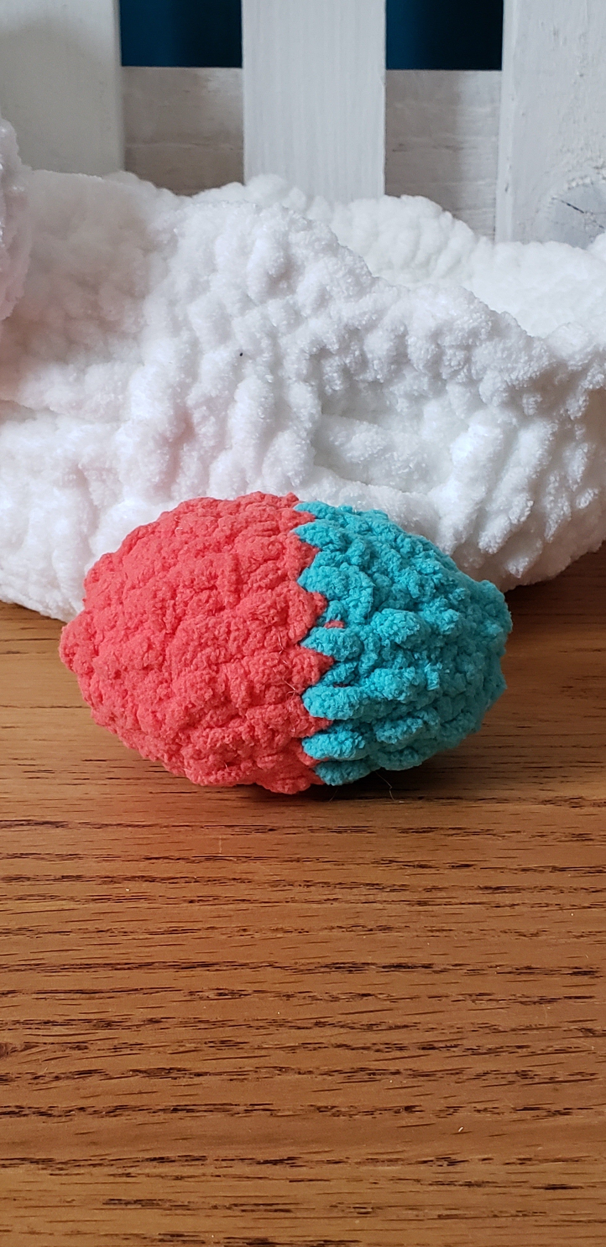 Teal and coral two-tone crochet Easter egg close-up