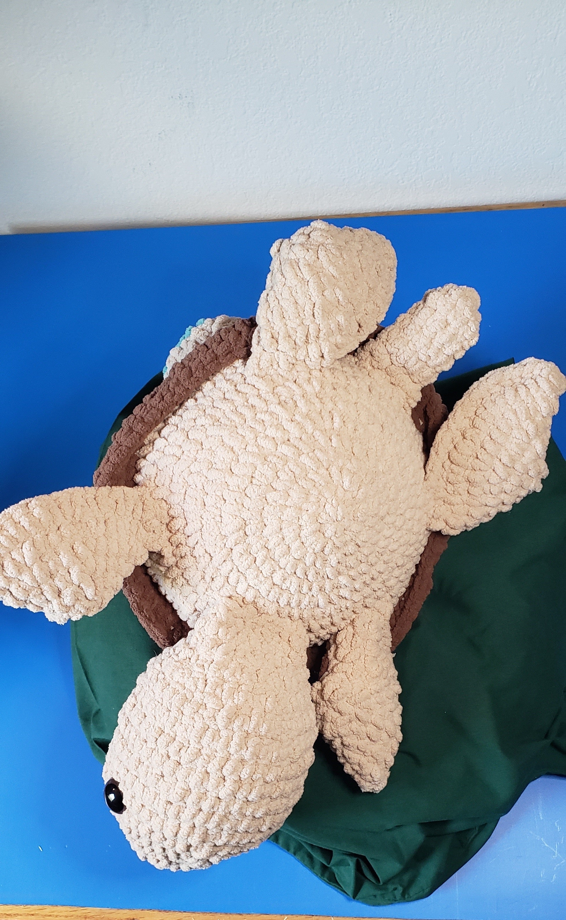 Crochet turtle plushie belly view showing four flippers