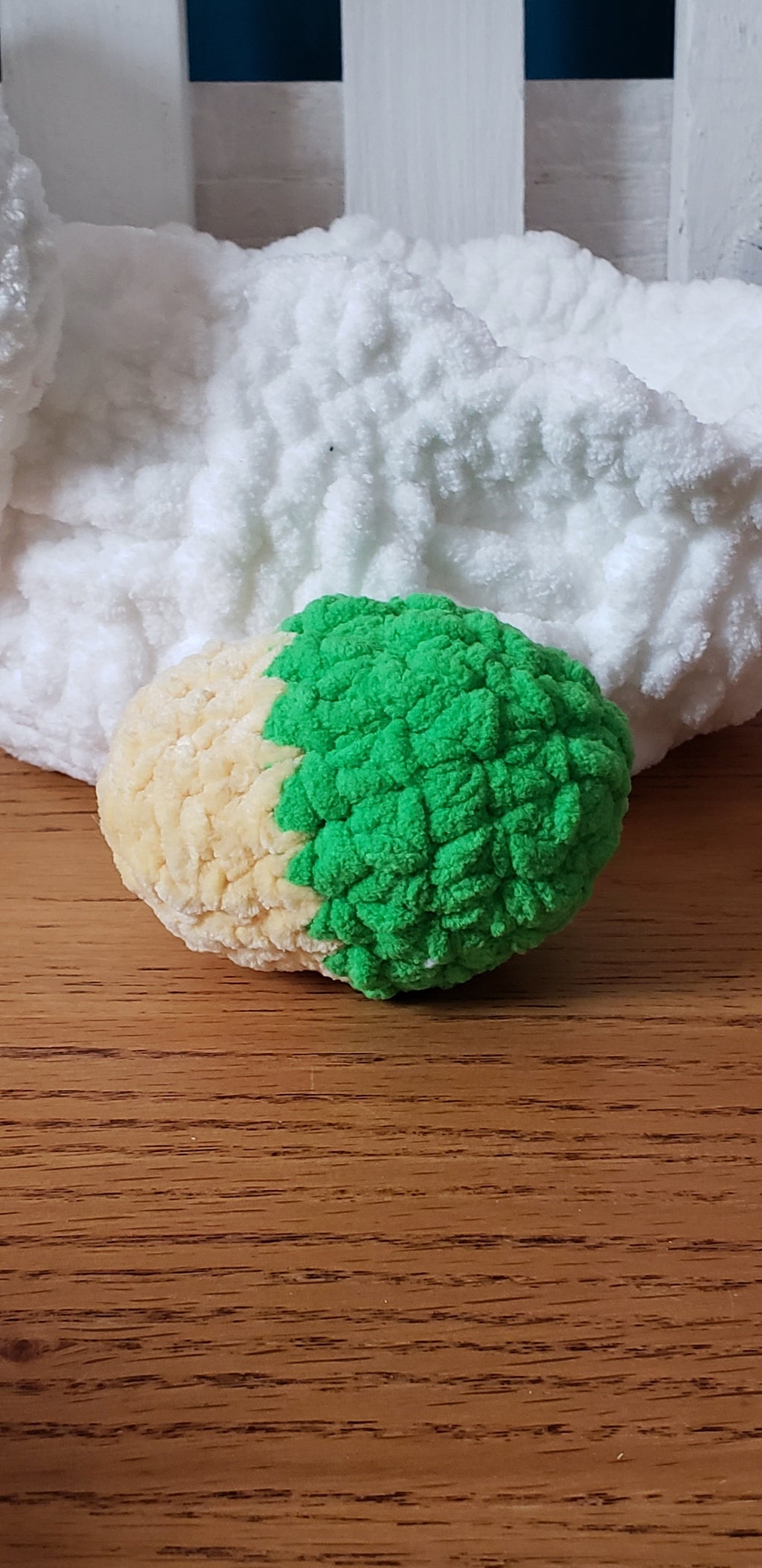 Green and yellow two-tone crochet Easter egg close-up