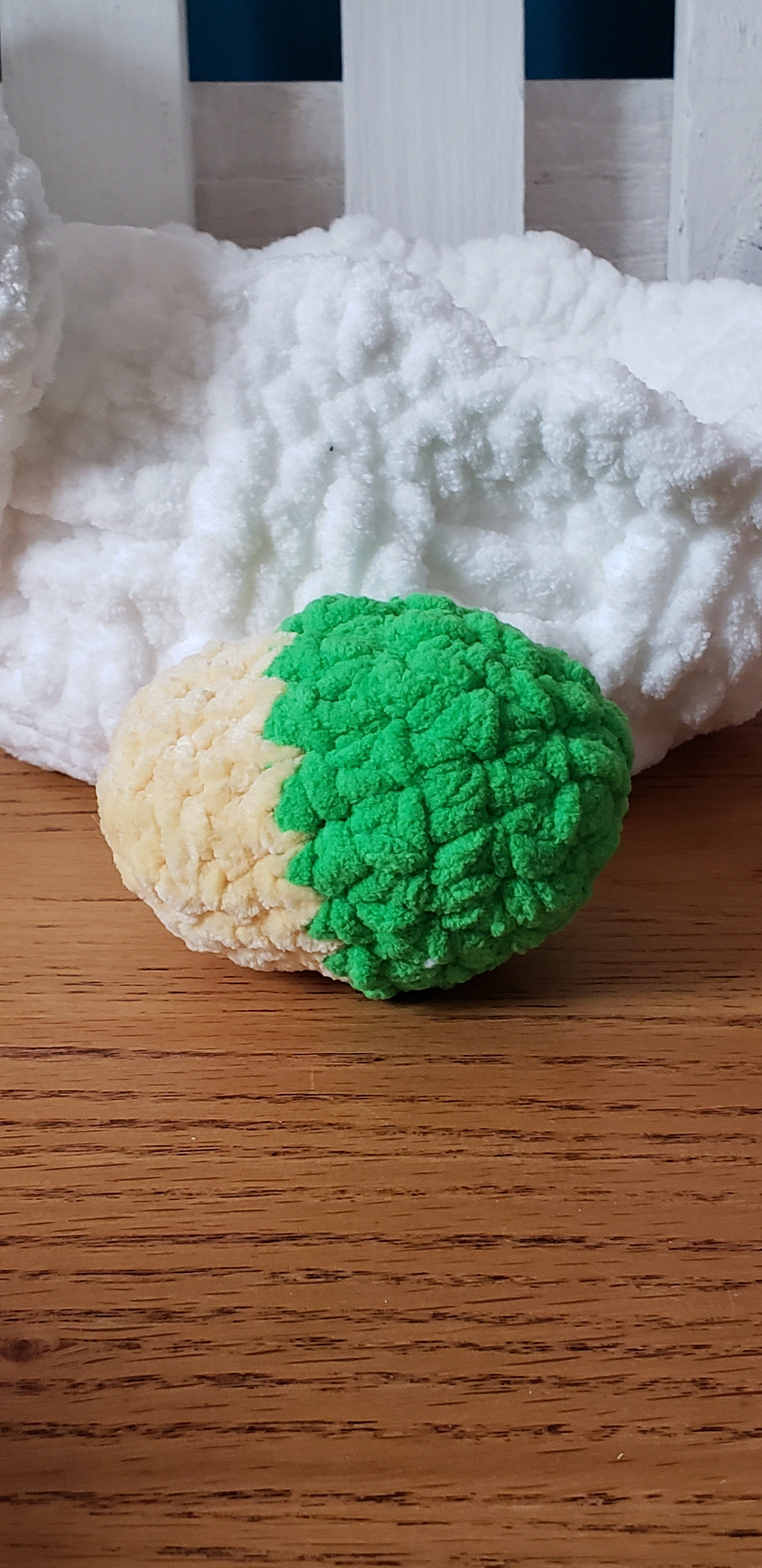 Green and yellow two-tone crochet Easter egg close-up